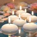 White floating candles set of 30 glowing in a glass bowl of water